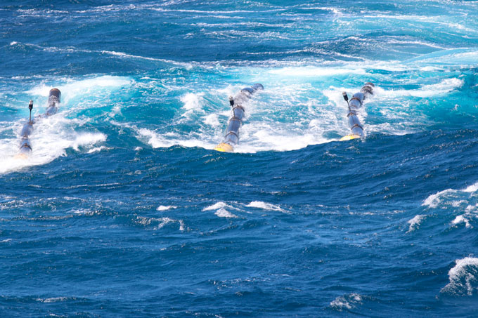 Scientific instruments are shown being towed through the sea.