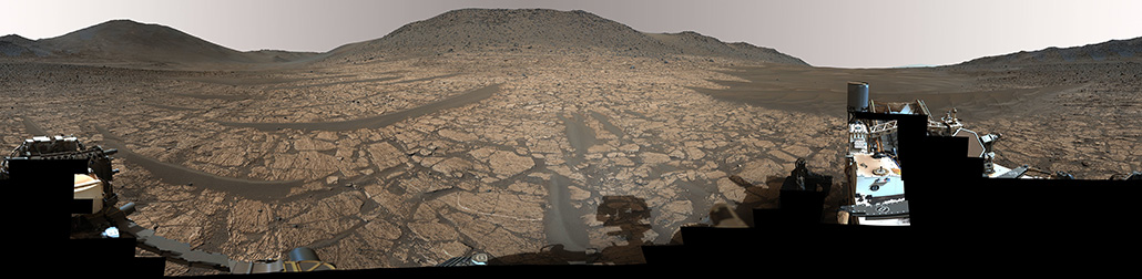 A panarama of an ancient river delta on Mars called Jezero Crater, where the NASA rover Perseverance (partially seen in the foreground) found a rock that may hold hints of ancient life on the Red Planet.